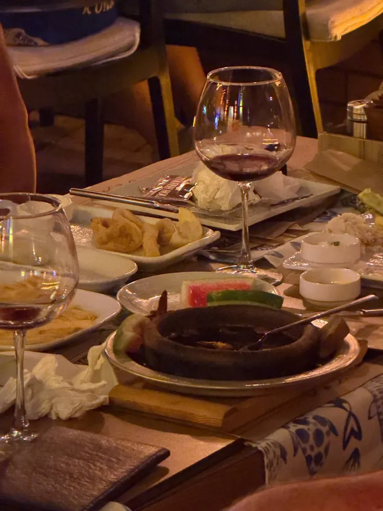 Kaş'ta Etna Fish House'da sıcak taşta karides ve kalamar tava ile akşam yemeği masası